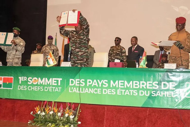 The head of Niger's military government, General Abdourahamane Tiani; Malian Colonel Assimi Goita; and Burkinabe Captain Ibrahim Traore show the documents of the Confederation of Sahel States (AES) they signed during their first summit in Niamey July 6, 2024 - PHOTO/AFP