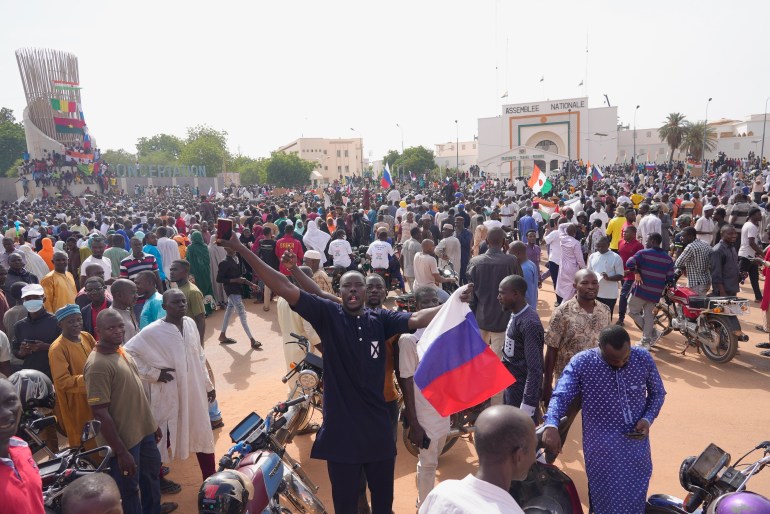 Nigeriens, some holding Russian flags, participate in a march called by supporters of coup leader Gen. Abdourahmane Tchiani in Niamey, Niger, Sunday, July 30, 2023. Russia's Wagner Group, a private military company led by Yevgeny Prigozhin, has played a key role in the fighting in Ukraine and also deployed its personnel to Syria, Libya and several African countries. Prigozhin's presumed death in a plane crash along with some of his top lieutenants raises doubts about the future of the military contractor. (AP Photo/Sam Mednick)