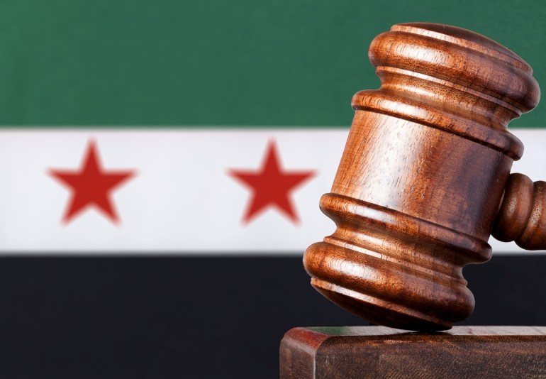 Hardwood gavel against the national flag of Syria. Selective focus. Canon 100mm f2.8 macro lens.