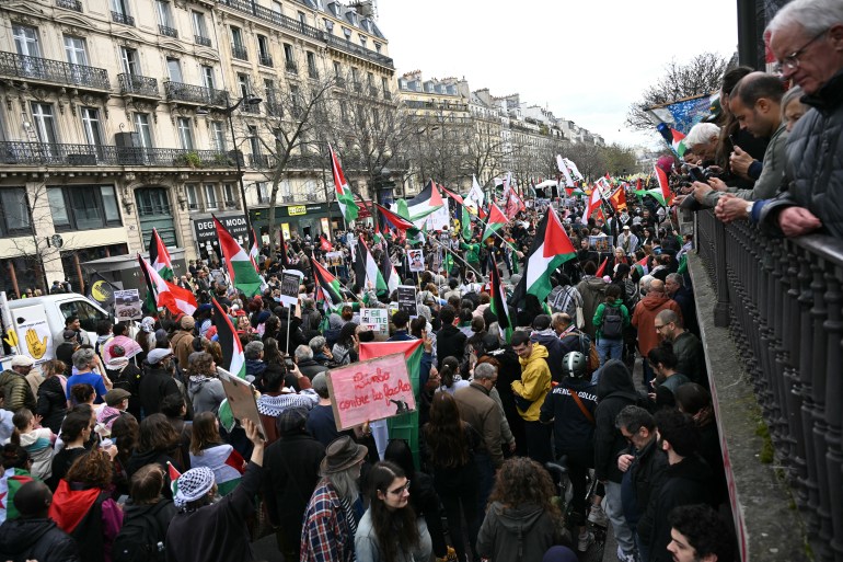 Protestors wave Palestinian flags during a demonstration on Place de la Republique in Paris on March 22, 2025, as part of the international day against racism and fascism. (Photo by Bertrand GUAY / AFP)