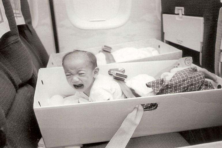Babies were placed into filing boxes with seatbelts looped through the carry-holes [Courtesy of Frederick Burkle]