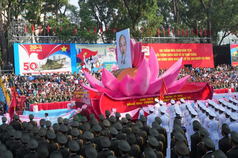 A float carrying a portrait of the late Vietnamese revolutionary leader Ho Chi Minh takes part in a parade during the 50th anniversary celebration of the end of the Vietnam War Wednesday, April 30, 2025, in Ho Chi Minh City, Vietnam. (AP Photo/Achmad Ibrahim)