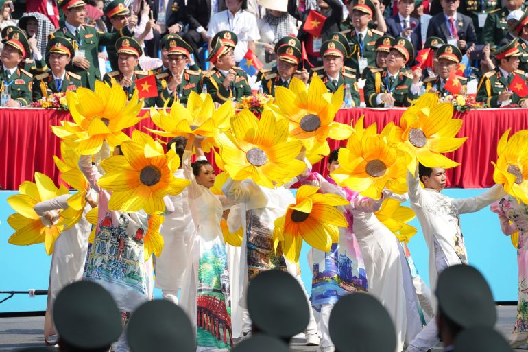 Vietnamese dancers perform during a parade celebrating the 50th anniversary of the end of the Vietnam War in Ho Chi Minh City, Vietnam, Wednesday, April 30, 2025. (AP Photo/Achmad Ibrahim)