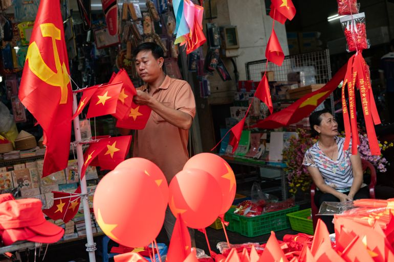 HO CHI MINH CITY, VIETNAM - APRIL 28: People shop for handheld Vietnamese national flags and patriotic accessories at a street stall ahead of the official celebrations on 30th April on April 28, 2025, in Ho Chi Minh City, Vietnam. (Photo by Thanh Hue/Getty Images)