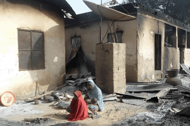 6 دول أفريقية على قائمة مؤشر الإرهاب العالمي.. ما دلالات ذلك؟ 1 TOPSHOT-NIGERIA-UNREST-ISLAMISTS TOPSHOT - A mother sits mourning the death of her husband after Boko Haram attacks at Dalori village on the outskirts of Maiduguri in northeastern Nigeria on January 31, 2016. Around 50 people were killed when Boko Haram fighters armed with guns and explosives attacked a village in northeastern Nigeria, medics and local residents said on on January 31. Nigeria's army said the gunmen attacked Dalori just outside the northern city of Maiduguri late on January 30, burning down the village and sending residents fleeing into the bush. (Photo by STRINGER / AFP) (Photo by STRINGER/AFP via Getty Images)