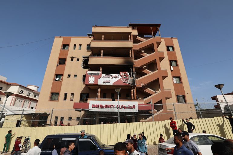 بالصور.. مستشفى ناصر الطبي يُقصف بمرضاه 5 People and traffic pass the fence of the Nasser hospital in Khan Yunis which was hit in an Israeli strike at dawn that targeted the southern Gaza Strip city on May 13, 2025.
