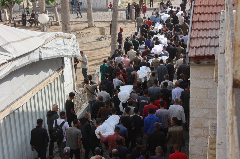 إسرائيل أحرقت النازحين نياما في مجزرة حي الدرج 5 Palestinian mourners walk in the funeral procession of relatives killed in an Israeli airstrike that hit an UNRWA school, serving as a shelter for people who left their homes in the besieged Palestinian territory, on the grounds of Gaza City's Al-Ahli Arab hospital, also known as the Baptist hospital, on May 20, 2025.
