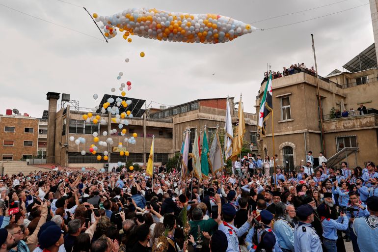 Members of the Greek Orthodox Church in Syria march to mark Palm Sunday in the predominantly Christian al-Qassaa neighborhood of Damascus, Syria, Sunday, April 13, 2025. (AP Photo/Omar Sanadiki)