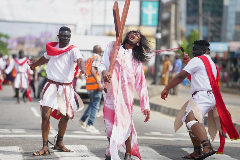 Members of the St Francis Catholic Church take part in a Way of the Cross re-enactment of the crucifixion of Jesus Christ on Good Friday during Holy Week in Lagos, Nigeria [File: Sunday Alamba/AP Photo]
