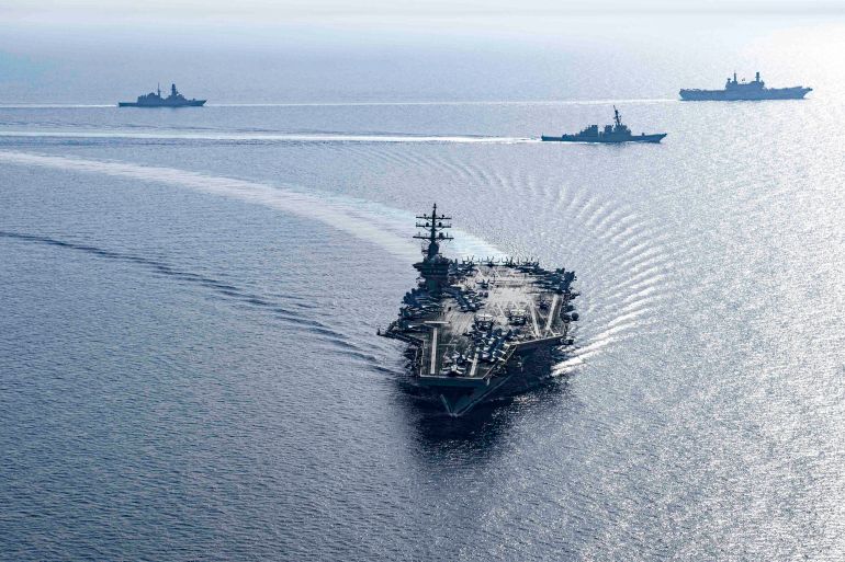 وول ستريت جورنال: كيف استطاع الحوثيون قض مضاجع البحرية الأميركية؟ 1 This handout photo released by the US Defence Visual Information Distribution Service (DVIDS) shows the US Navy Nimitz-class aircraft carrier USS Dwight D. Eisenhower (CVN 69) and Arleigh Burke-class guided-missile destroyers USS Laboon (DDG 58) and USS Gravely (DDG 107), part of the Dwight D. Eisenhower Carrier Group (IKECSG), sailing in formation in the Red Sea with the Italian aircraft carrier ITS Cavour (CVH 550) on June 7, 2024, as part of their mission to support maritime stability and security in the Middle East region. (Photo by DVIDS / AFP) / RESTRICTED TO EDITORIAL USE - MANDATORY CREDIT "AFP PHOTO / US NAVY " - NO MARKETING NO ADVERTISING CAMPAIGNS - DISTRIBUTED AS A SERVICE TO CLIENTS