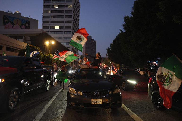 بالصور.. احتجاجات لوس أنجلوس 1 epa12167402 Protestors wave Mexican flags during protests sparked by immigration raids in Los Angeles, California, USA, 09 June 2025. US President Donald Trump has deployed 2,000 National Guard troops, despite not receiving a request from the state of California for any additional assistance, following large protests against ongoing immigration enforcement raids in the Los Angeles area over the last couple of days. EPA-EFE/ALLISON DINNER